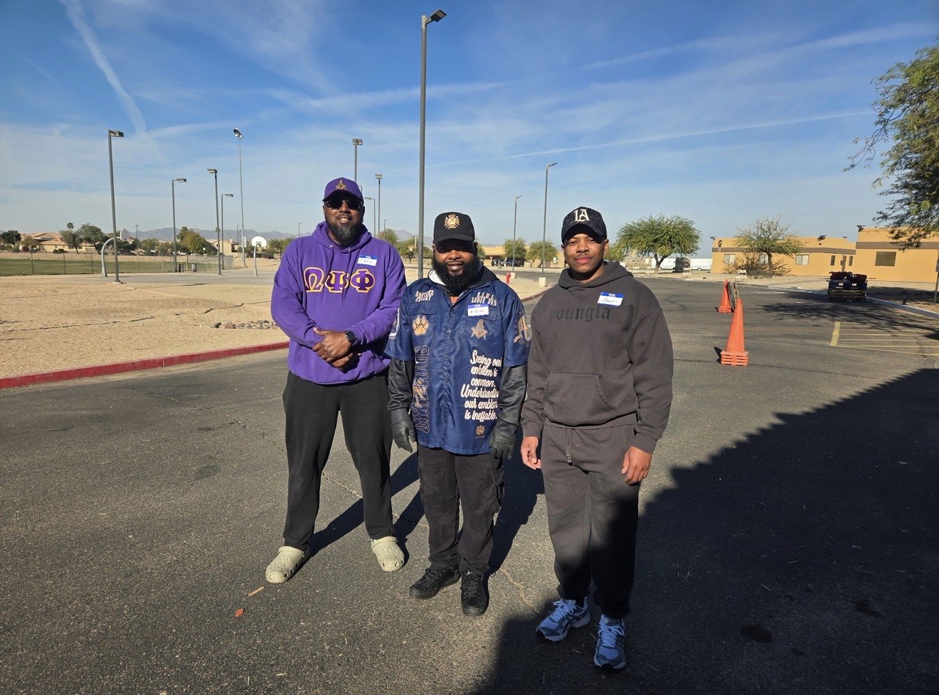 Courtney Boss, Anton Crosby Sr. and a young volunteer at a food distribution